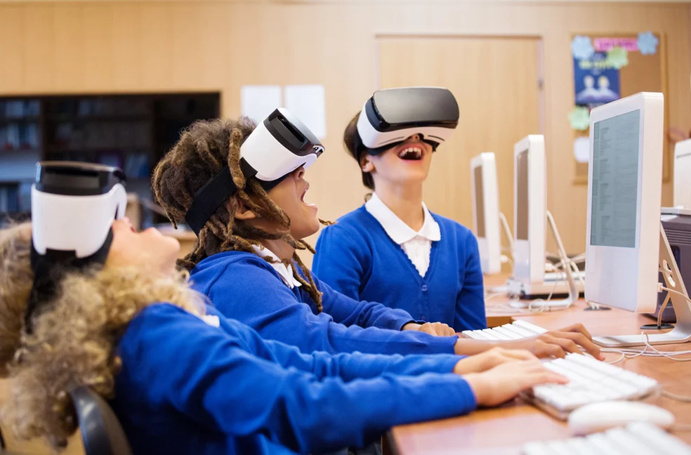 Students using VR headsets alongside the immersive wall
